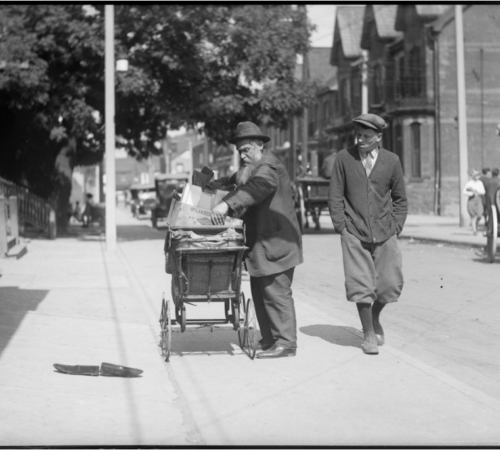 Screen Shot 2020-04-29 at 4.01.22 PM A man loads a perambulator with goods in Kensington in the 1920's. City of Toronto Archives, Globe and Mail fonds, Fonds 1266, Item 8244.