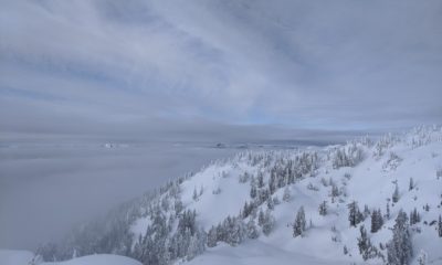 A shot of a peak on Mount Seymour with clouds hanging around the mountain.
